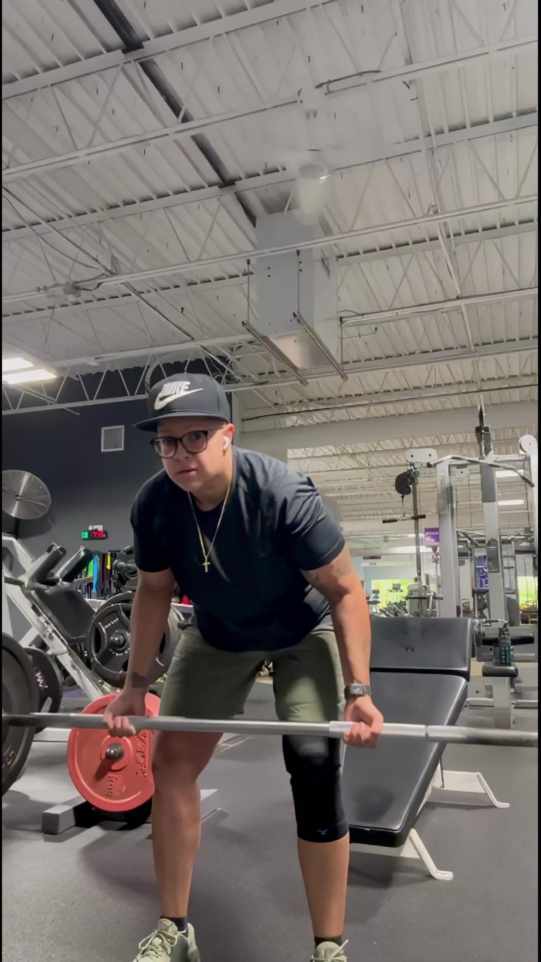 Carissa setting up a barbell row in the gym